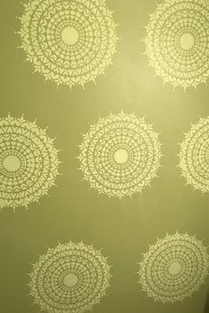 an image of a bathroom with green walls and white circles on the shower stall wall