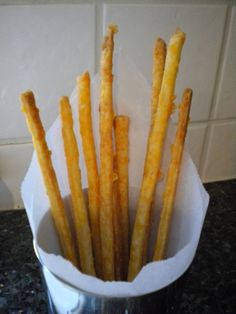 some french fries are in a cup on the counter