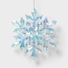 a snowflake ornament hanging from a string