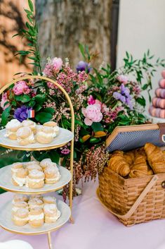 a table topped with three tiered trays filled with pastries