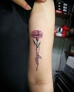 a woman's arm with a flower tattoo on it and the word hope written in cursive writing