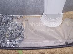 a pile of rocks sitting on top of a floor next to a white pole and door