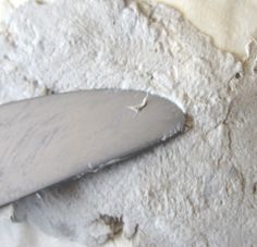 a close up of a knife on a piece of white paper with holes in it