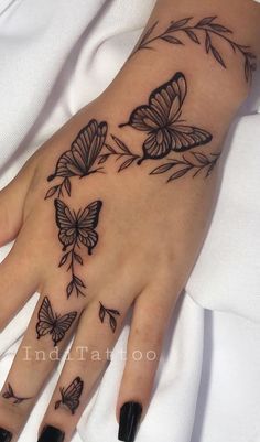 a woman's hand with butterflies on it