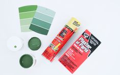 the supplies needed for painting are laid out on a white surface, including green paint