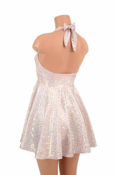 "This item is made to order, please read all the way through the listing before purchasing! This flowy dress is made of pink & silver round scale holographic spandex. The halter top is darted and ties behind the neck, the hemline is circle cut. Length: 17\" measured from the waist to the hemline. We can create this dress from any other fabric in our shop, just ask! Womens Sizing (See below for instructions on where measurements should be taken) XXS: Bust 29\"-30\" / Waist 22\"-23\" / Hips 30 Pink Sequin Shimmer Dress For Summer, Glamorous Pink Backless Halter Dress, Glamorous Iridescent Shimmer Dress, Spring Fitted Iridescent Mini Dress, Fitted Iridescent Mini Dress For Spring, Pink Fitted Sequin Dress With Shimmer, Spring Iridescent Fitted Mini Dress, Pink Fitted Halter Backless Dress, Iridescent Fitted Mini Dress For Party