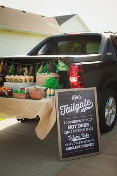 a tailgate truck is selling hot dogs and condiments