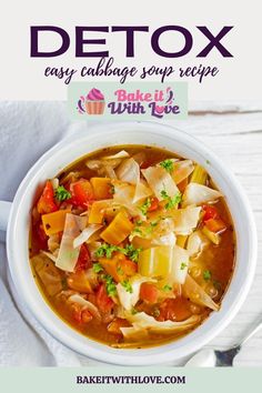 a white bowl filled with soup next to a spoon