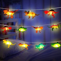 PRICES MAY VARY. Funny dinosaur string lights: 30 pieces of led dinosaur decorations light in 16.4 feet, including 8 different dinosaurs, such as stegosaurus, together creating a dinosaur world to your house, helping to release imagination out of children; Powered by 3 x AA batteries (not included), safe to touch Ideal gifts for kids: cute string lights to inspire interest of your kids, and if they are dinosaur fans, you will not miss out on this fantastic led string light; Decorate kid's bedroo Room Decor For Boys, Tent Garden, Dinosaur Lamp, Dinosaur Decor Bedroom, Dinosaur Room Decor, Dinosaur Light, Dinosaur Bedroom, Dinosaur Room, Battery String Lights