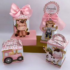 four pink boxes with farm animals on them, one has a cow and the other has a horse