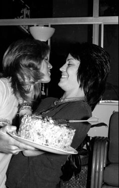 black and white photograph of two women sharing a piece of cake