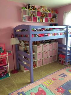 a child's bedroom with pink walls and purple bunk beds