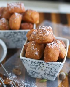 small bowls filled with powdered sugar covered pastries