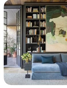 a living room filled with furniture and bookshelves