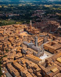 an aerial view of a city with tall buildings and brown roof tiles on the streets