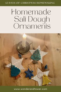 homemade salt dough ornaments on a table with a candle in the middle and other ornaments