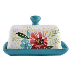 a blue tray with a flower design on the front and bottom, holding a serving dish