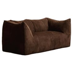 a brown couch sitting on top of a white floor