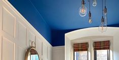 a bathroom with blue ceiling and white walls