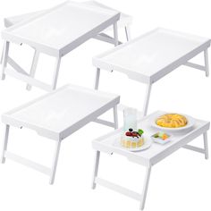 three white tables with trays and plates on them