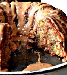 a bundt cake covered in icing on top of a pan