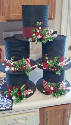 four tiered cakes decorated with candy canes and holly wreaths on top of each other