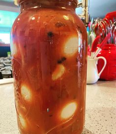 a jar filled with liquid sitting on top of a counter