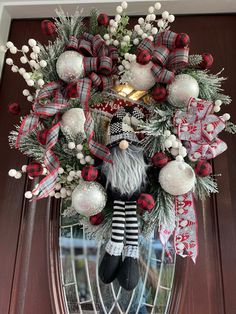 a christmas wreath hanging on the front door