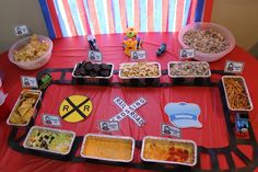 a red table topped with lots of food