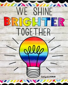 we shine brighter together sign with lightbulb and rainbow colors on wood planks