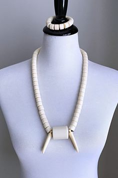 This is a traditional West African off-white beaded necklace for men and women. These jewelry pieces are unisex and are designed to be worn by adults Beads are made of plastic Length ( from neck to chest): 15.5 inches Comes with one (1) matching elastic bracelet These beaded jewelry is an integral part of West African culture. Traditionally it is worn by Royalty, Chiefs, and those who are part of the Royal households among many kingdoms in West Africa. It is also worn by brides and grooms during Traditional White Adjustable Choker, White Adjustable Traditional Choker, White Spiritual Jewelry With Wooden Beads, Spiritual White Jewelry With Wooden Beads, White Wooden Beads Jewelry, White Wooden Beaded Jewelry, Spiritual White Necklaces With Polished Beads, White Large Beads Spiritual Jewelry, White Spiritual Necklace With Polished Beads