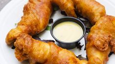 fried food on a plate with dipping sauce