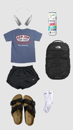 the contents of a backpack, shoes, and t - shirt laid out on a gray background