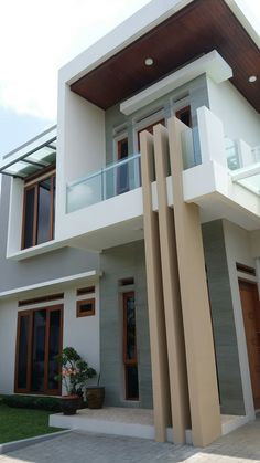 a modern house with large windows and balconies