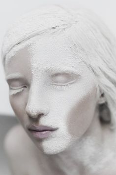 a woman's face is covered in white powder