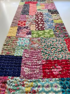 a patchwork table runner made out of colorful fabrics