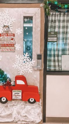 a red truck is parked in front of a christmas tree with snowflakes on it