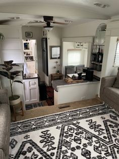 a living room filled with furniture and a rug