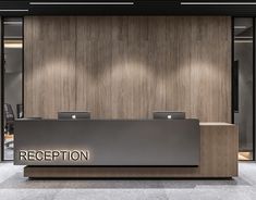 the reception desk has two laptops on it