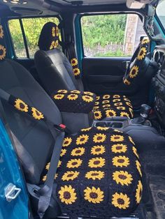 the sunflowers are crocheted on the seat covers in the truck's interior