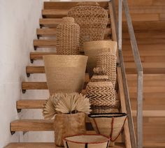 baskets and vases are lined up on the stairs