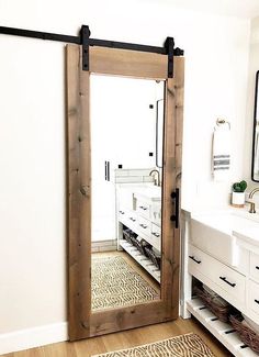 a bathroom with a large mirror and sliding door in it's center area, next to a sink