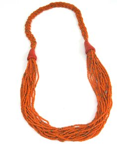 here is a wonderful and bold orange statement glass beaded rope necklace from kenya, africa. the masai. this measures about 28 inches in length. although this is vintage, it still makes a bold statement. so why not, need a vintage gift ? Traditional Orange Beaded Necklace With Gold Beads, Orange Beaded Costume Jewelry Necklaces, Bohemian Fair Trade Orange Jewelry, Fair Trade Bohemian Orange Jewelry, Fair Trade Orange Bohemian Jewelry, Traditional Orange Multi-strand Jewelry, Orange Hand-strung Multi-strand Jewelry, Orange Multi-strand Hand-strung Jewelry, Luxury Orange Hand-strung Beaded Necklace