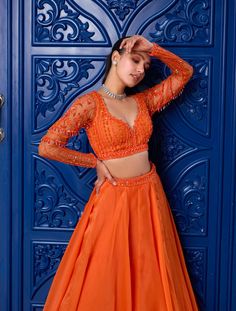 Radiate warmth and elegance in this orange hand-embroidered tonal blouse! Intricately embellished with sequins, glass beads, and stones, it adds a touch of opulence to your ensemble. Paired with a flowy silk organza skirt featuring a soft can-can, it offers a graceful silhouette. Complete your look with a net dupatta adorned with diagonal lines embroidery, adding a dash of sophistication. Embrace timeless charm with this captivating attire, perfect for making a statement at any special occasion. Lines Embroidery, Sharara Gharara, Diagonal Lines, Organza Skirt, Can Can, Western Wedding, Net Dupatta, Silk Organza, Wedding Service