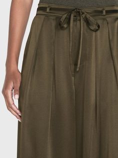 A 100% silk high rise, wide-leg trouser with front center pleats for a dramatic silhouette that drapes beautifully. Featuring a skinny waist tie for an adjustable fit and side and back pockets. High Rise FitDry Clean Only100% Silk13.25" Front Rise/32" Inseam/28.5" Leg Opening Dramatic Silhouette, Silk Trousers, Menswear Inspired, Turks And Caicos Islands, Military Green, Brunei, Pleated Dress, Waist Tie, Black Tie