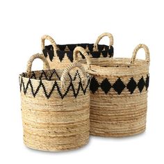 three black and white baskets sitting on top of a table