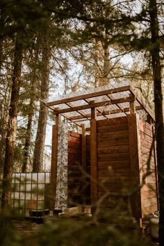 a wooden structure in the middle of some trees