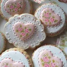 decorated cookies with pink and white frosting in the shape of hearts