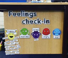 feelings check - in sign with stickers on it