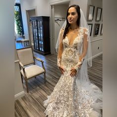 a woman in a wedding dress posing for the camera